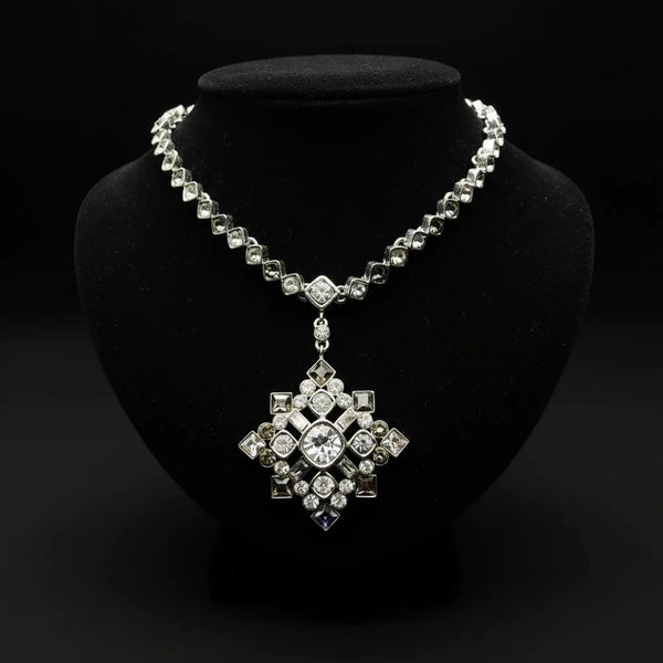 This is a stunning necklace, made of a chain of clear and gray diamond shaped rhinestones, and from it is suspended a breathtaking element. 