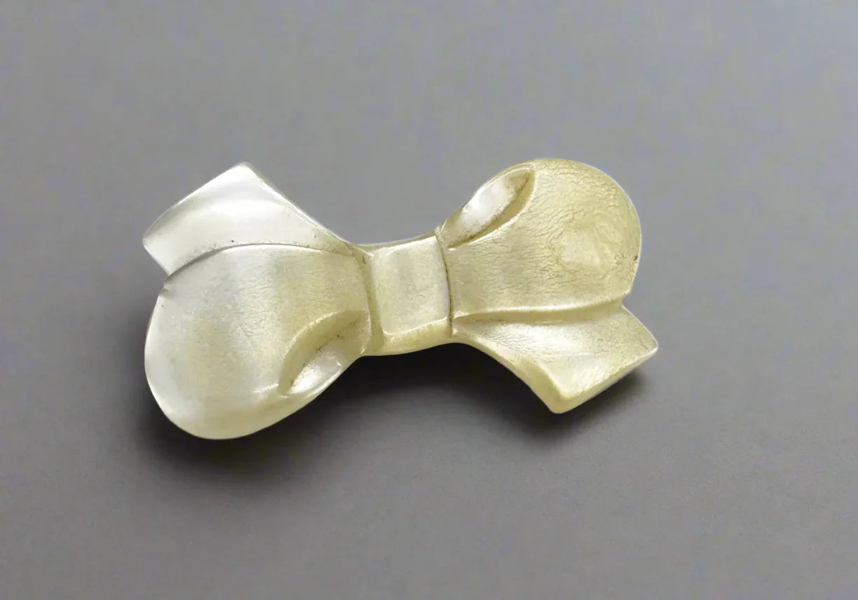 Make a statement with this elegant bow brooch! Its unique design is sure to turn heads and add a touch of glamour to any outfit. At 2.5 inches, this brooch is the perfect size to make a subtle yet stunning statement