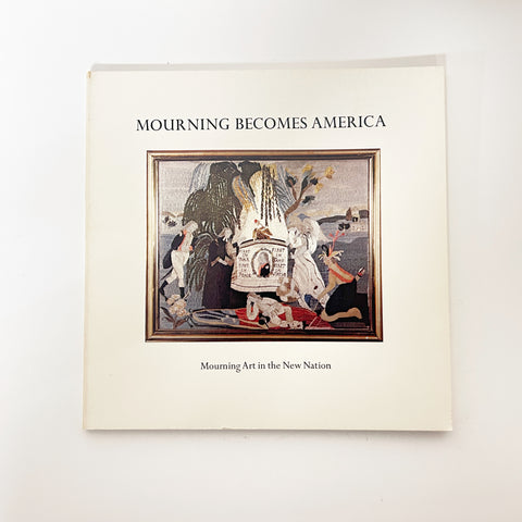 Book titled 'Mourning Becomes America' on a white background