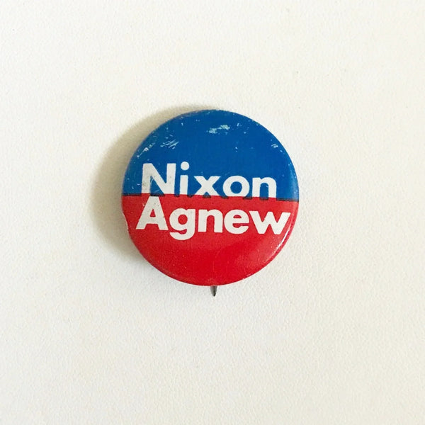 Celebrate a pivotal moment in American political history with the Nixon-Agnew Pin Back from the 1972 presidential campaign. Featuring bold red and blue colors with crisp white lettering, this vintage pin showcases the names of incumbent President Richard M. Nixon and Vice President Spiro Agnew, representing the Republican Party. 