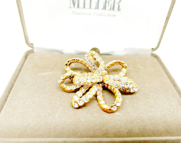 Discover a rare glamour brooch by Nolan Miller, a super sparkly 3D ribbon design in rich gold metal with bright clear stones. Free shipping included!