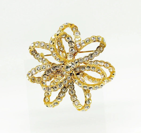 Discover a rare glamour brooch by Nolan Miller, a super sparkly 3D ribbon design in rich gold metal with bright clear stones. Free shipping included!
