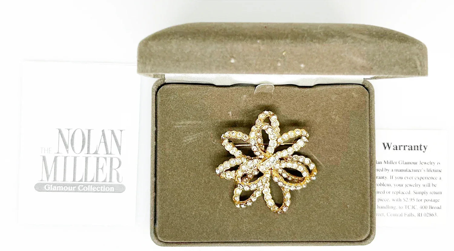 Discover a rare glamour brooch by Nolan Miller, a super sparkly 3D ribbon design in rich gold metal with bright clear stones. Free shipping included!