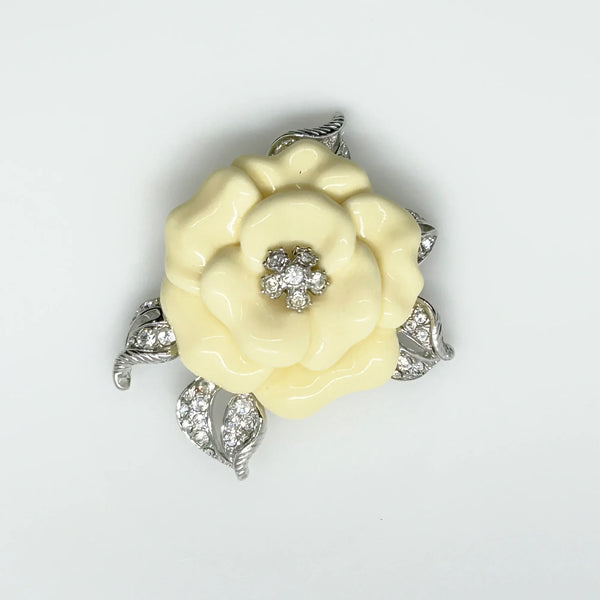Perfect for those who appreciate timeless glamour: our Nolan Miller Lara Camellia Brooch provides a creamy flower brooch with sparkling elegance. Shop today!