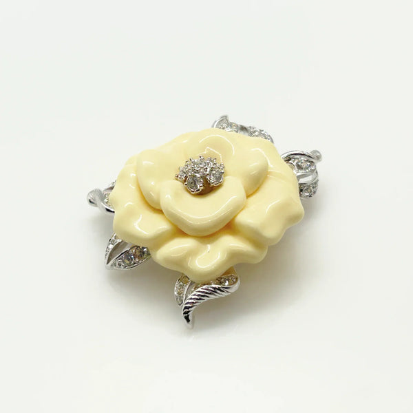 Perfect for those who appreciate timeless glamour: our Nolan Miller Lara Camellia Brooch provides a creamy flower brooch with sparkling elegance. Shop today!