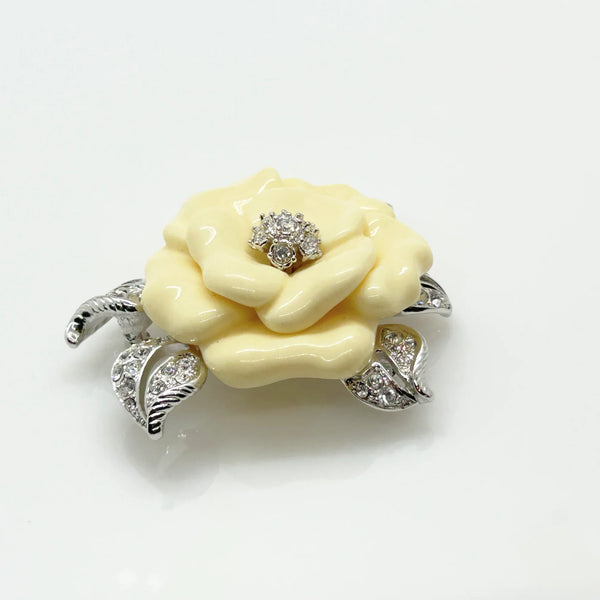 Perfect for those who appreciate timeless glamour: our Nolan Miller Lara Camellia Brooch provides a creamy flower brooch with sparkling elegance. Shop today!