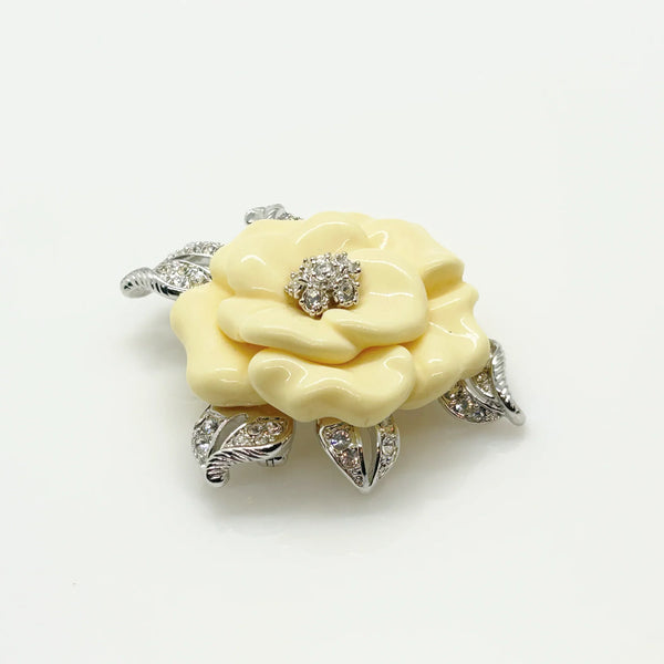 Perfect for those who appreciate timeless glamour: our Nolan Miller Lara Camellia Brooch provides a creamy flower brooch with sparkling elegance. Shop today!