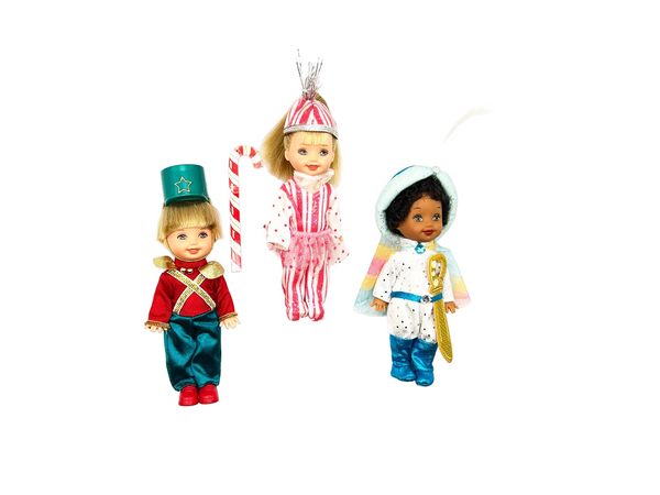 Front view of a 2001 Mattel Barbie in the Nutcracker Kelly Club multi-doll collectible set. The 3-doll lot includes miniature character figures of Tommy in a red toy soldier outfit, Kelly with blonde hair in a peppermint stripe dress, and an African American Tommy figure wearing a white and blue uniform with a golden staff