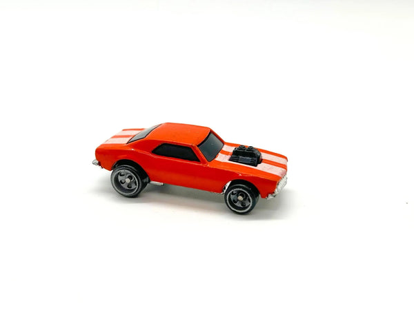 A small red toy muscle car with white racing stripes and black wheels, photographed on a plain white background.