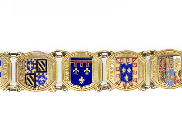 Perfect for vintage jewelry lovers: our Vintage French Souvenir Panel Bracelet provides a stunning display of French heraldic crests. Shop today!