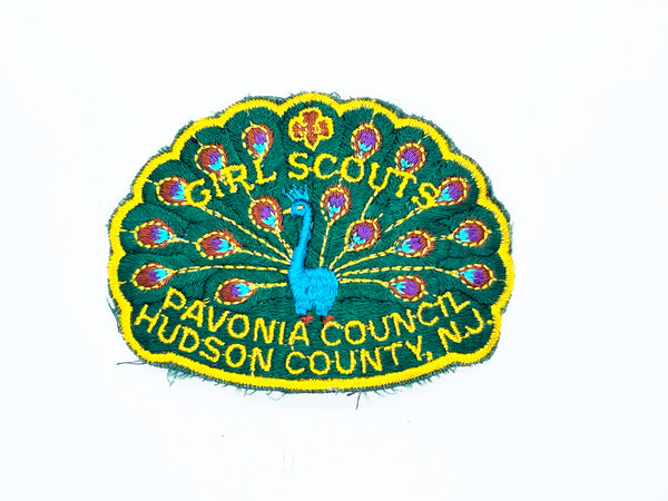 Celebrate Girl Scout heritage with this authentic vintage Pavonia Council patch from Hudson County, New Jersey. The striking peacock design served as the council's proud symbol, representing the organization's values and spirit. 