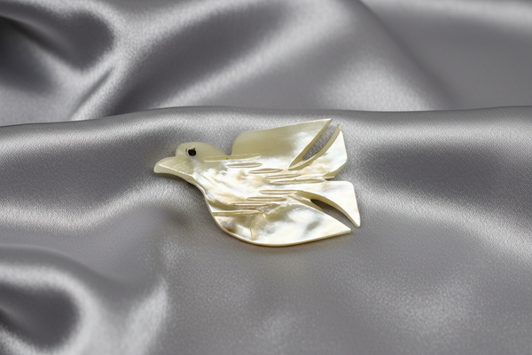 Perfect for vintage jewelry lovers: our Hand Carved Vintage Mother of Pearl Peace Dove Pin- 1960s provides a timeless symbol of peace. Shop today!