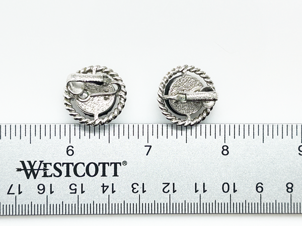 Discover the captivating allure of these authentic Sarah Coventry "Northern Lights" clip-on earrings, a stunning find from the 1960s-70s era. The dichroic glass centers showcase an extraordinary color-shifting quality that transforms from blue to green to purple to red as light dances across the surface—creating a mesmerizing effect that draws admiration from every angle.