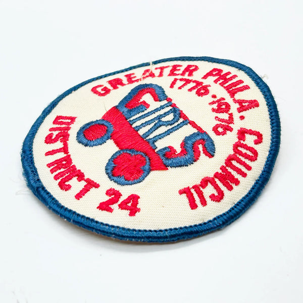 This vintage Greater Phila. Girls Council District 24 patch from the American Bicentennial period features the dates "1776-1976" embroidered in red along the top curve, commemorating the 200th anniversary of American independence. 