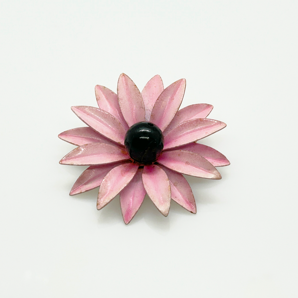 Bring a splash of retro charm to your collection with this delightful 1960s mod brooch! Featuring vibrant pink enamel petals arranged in a bold daisy design, it captures the spirit of the flower power movement that defined the swinging sixties. Shop Now!