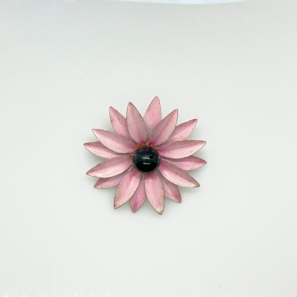 Bring a splash of retro charm to your collection with this delightful 1960s mod brooch! Featuring vibrant pink enamel petals arranged in a bold daisy design, it captures the spirit of the flower power movement that defined the swinging sixties. Shop Now!
