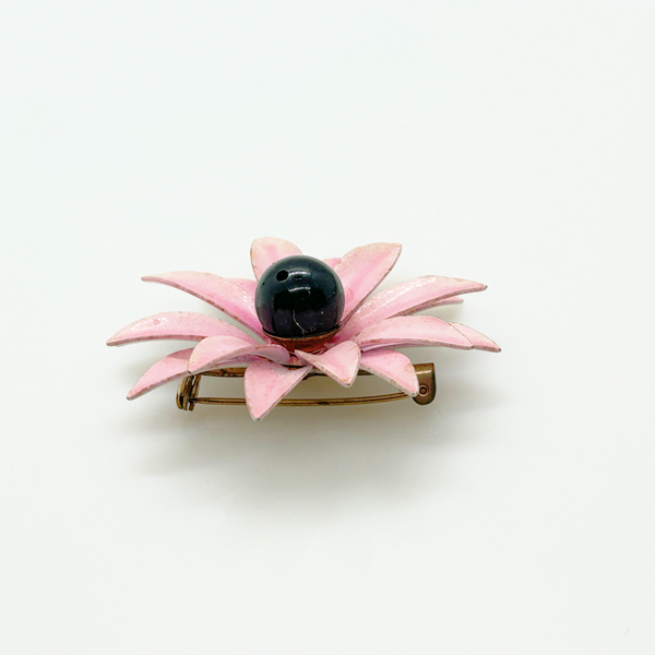 Bring a splash of retro charm to your collection with this delightful 1960s mod brooch! Featuring vibrant pink enamel petals arranged in a bold daisy design, it captures the spirit of the flower power movement that defined the swinging sixties. Shop Now!