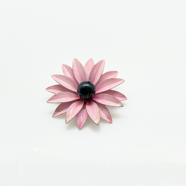 Bring a splash of retro charm to your collection with this delightful 1960s mod brooch! Featuring vibrant pink enamel petals arranged in a bold daisy design, it captures the spirit of the flower power movement that defined the swinging sixties. Shop Now!