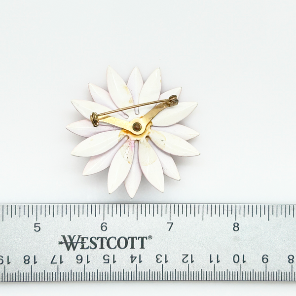 Bring a splash of retro charm to your collection with this delightful 1960s mod brooch! Featuring vibrant pink enamel petals arranged in a bold daisy design, it captures the spirit of the flower power movement that defined the swinging sixties. Shop Now!