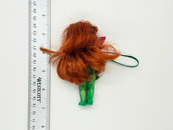  This charming Kelly Club figure features vibrant red hair, festive green tights, and an adorable poinsettia-themed dress that captures the spirit of the season