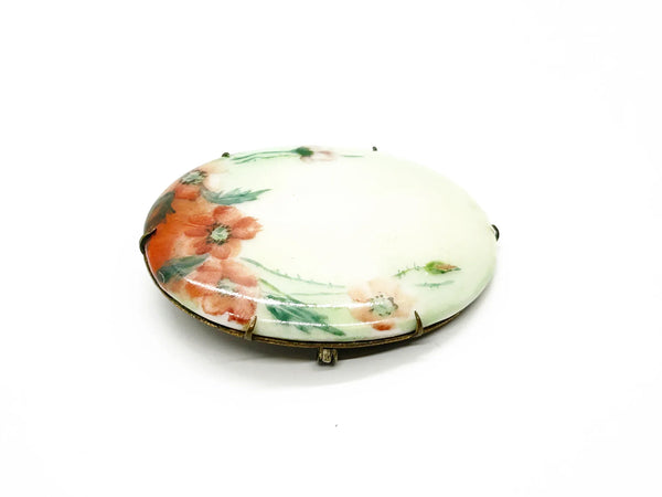 A charming slice of history pinned to your lapel! This delicate porcelain red poppy brooch whispers tales from the Victorian and Edwardian eras, hand-painted with the care artisans devoted to their craft over a century ago.