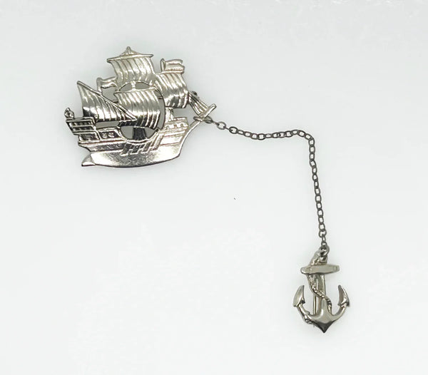 Step back in time with this charming vintage brooch set!! This whimsical dual brooch features a meticulously crafted sailing ship elegantly connected by a gleaming chain to a sturdy anchor. The intricate details and silver-tone finish are truly captivating, making this piece a delightful find for any vintage jewelry enthusiast