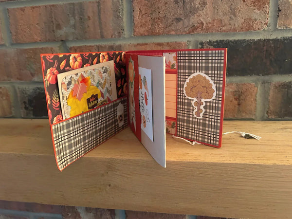 This handmade mini album captures the cozy spirit of autumn. With a warm palette of pumpkin spice, ochre, and wood grain, the album features a tempting cover hinting at a delightful caffeinated beverage. 