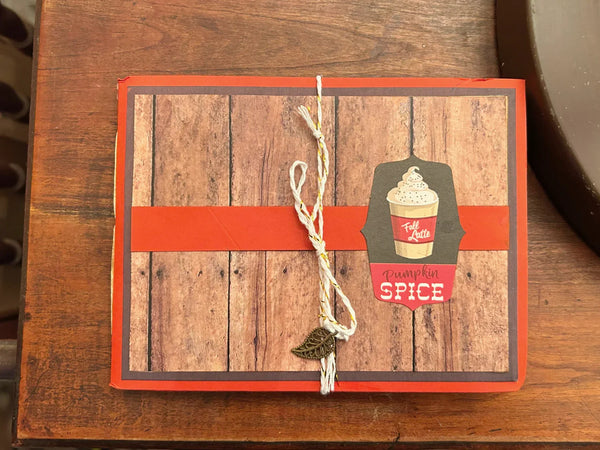 This handmade mini album captures the cozy spirit of autumn. With a warm palette of pumpkin spice, ochre, and wood grain, the album features a tempting cover hinting at a delightful caffeinated beverage. 