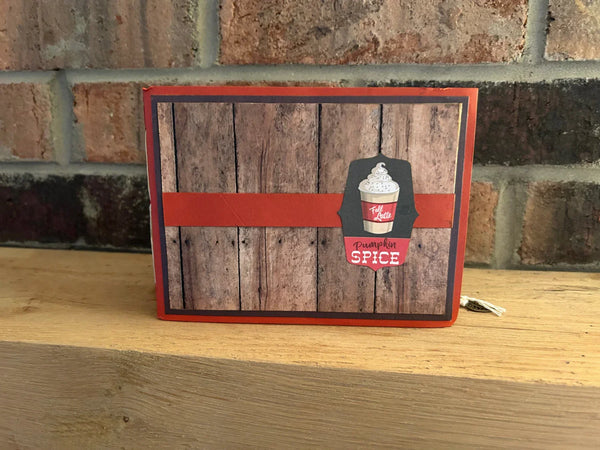 This handmade mini album captures the cozy spirit of autumn. With a warm palette of pumpkin spice, ochre, and wood grain, the album features a tempting cover hinting at a delightful caffeinated beverage. 