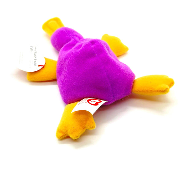 Purple and yellow plush toy with a visible brand tag on a white background