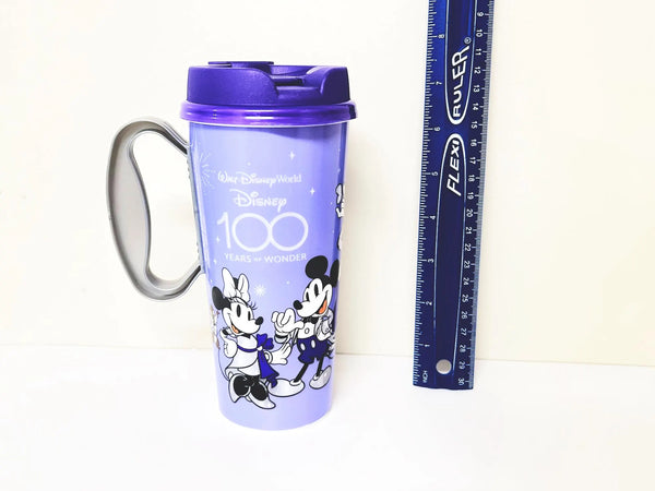 Walt Disney World 100th Anniversary Resort Refillable Tumbler Cup Mug featuring a vibrant purple design, released in 2023 for the "100 Years of Wonder" celebration. 