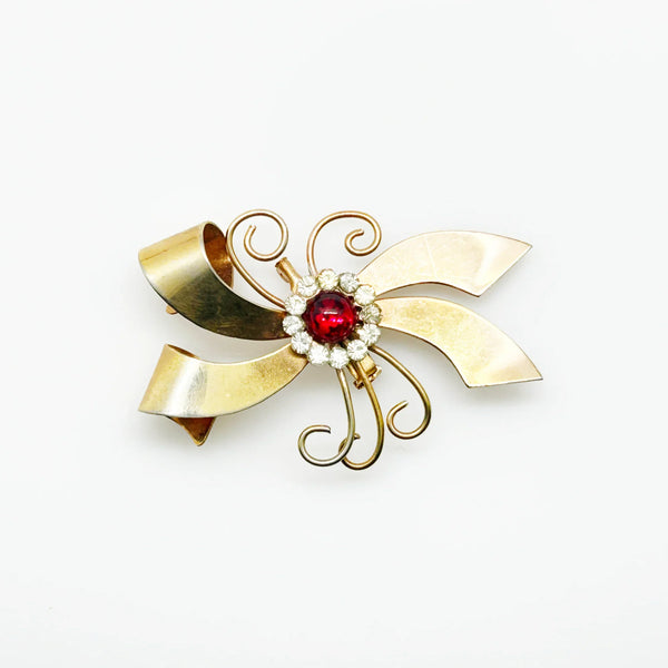 Perfect for vintage jewelry lovers: our Vintage Abstract Bow Brooch with Red Cabochon and Bright Rhinestones provides a unique, bold style boost. Shop today!