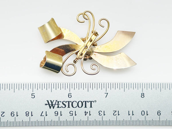 Perfect for vintage jewelry lovers: our Vintage Abstract Bow Brooch with Red Cabochon and Bright Rhinestones provides a unique, bold style boost. Shop today!