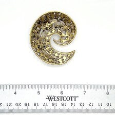 Scale reference view of the vintage pink rhinestone statement brooch next to ruler