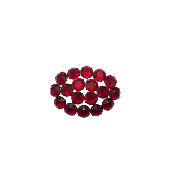 A cluster of faceted dark red rhinestones arranged in an oval shape on a plain white background.