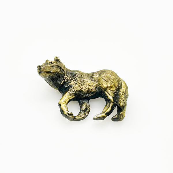 Antiqued bronze wolf brooch pin with highly detailed textured fur on a plain white background