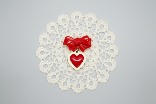 Perfect for vintage jewelry lovers: our Vintage Early Plastic Sweetheart Bow Pin provides nostalgic charm with iconic heart and bow design. Shop today!