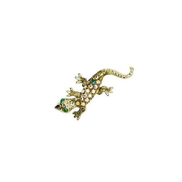This enchanting vintage salamander brooch captures the magic of mid-century costume jewelry with its shimmering Aurora Borealis rhinestones and lustrous gold-toned setting. The iridescent body gleams with multi-colored stones that shift and dance in the light, while striking green accents highlight the creature's expressive eyes.