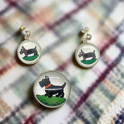This delightful sterling silver set features an adorable black Scottie dog that's ready to prance right into your jewelry collection! The charming brooch pin (1 1/8" x 1 1/8") adds a playful pop to any dress, sweater, blouse, or scarf, while the matching pierced post earrings (approximately 1 3/4" long) complete the look with tail-wagging style