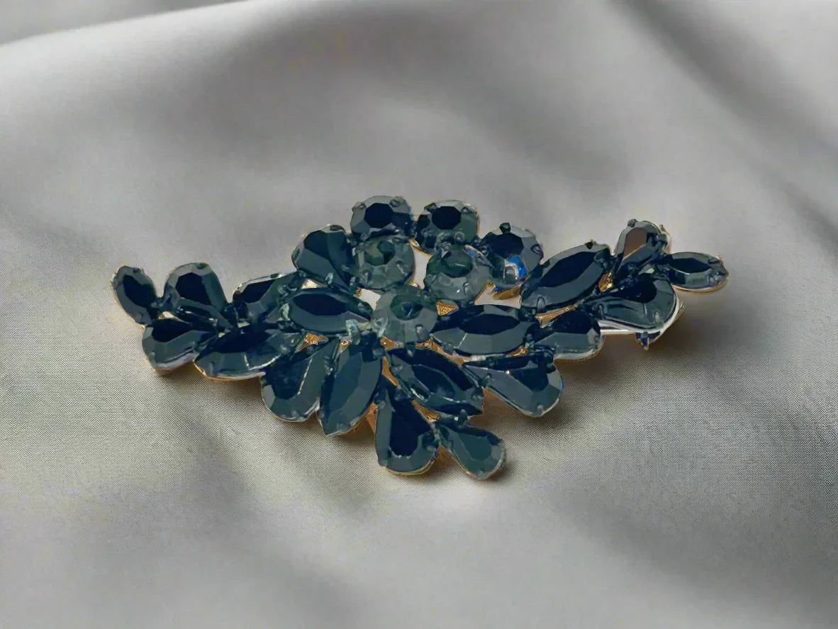 Discover the beauty and intrigue of our Vintage Brooch with Black and Dark Gray Stones. Adorned with captivating rhinestones that glimmer among the solid black stones, this brooch exudes sophistication and allure