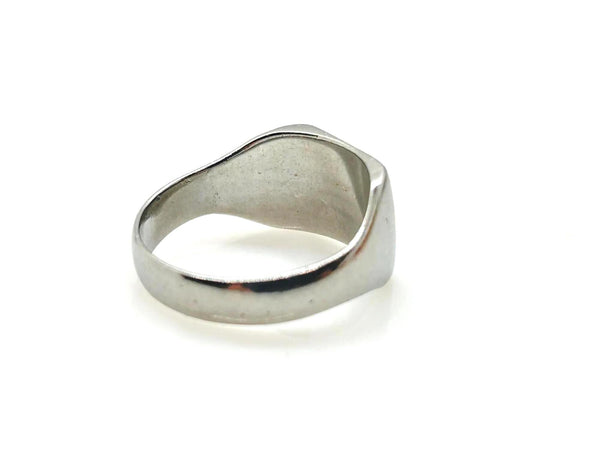 A polished silver signet ring with an organic, wavy outline, photographed on a seamless white background.