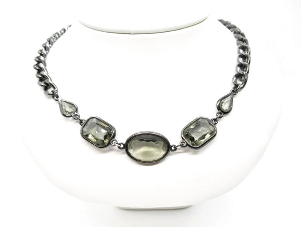 This stunning 1980s necklace features a sophisticated mix of oval, rectangular, and marquise-cut smoky glass stones, each expertly bezel-set into a blackened metal chain.