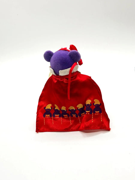 A small, purple plush bear ornament dressed as Snow White. 