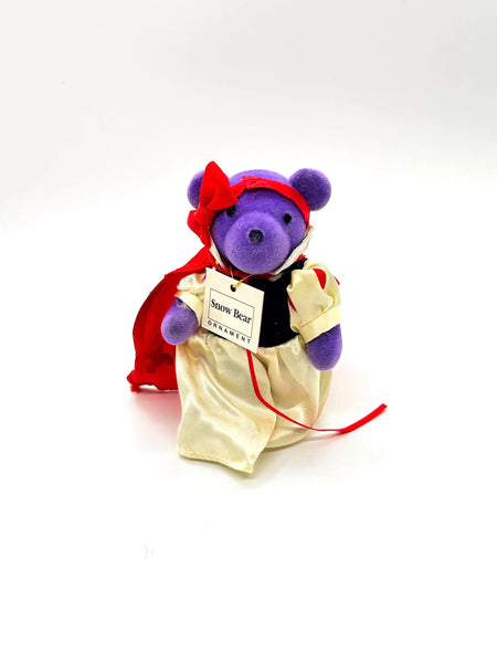 A small, purple plush bear ornament dressed as Snow White. 