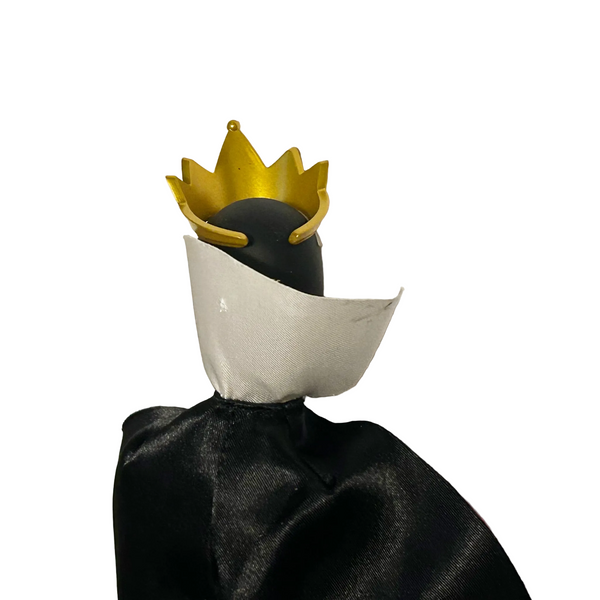 A black doll or figurine with a gold crown and a white collar, shown against a plain white background.