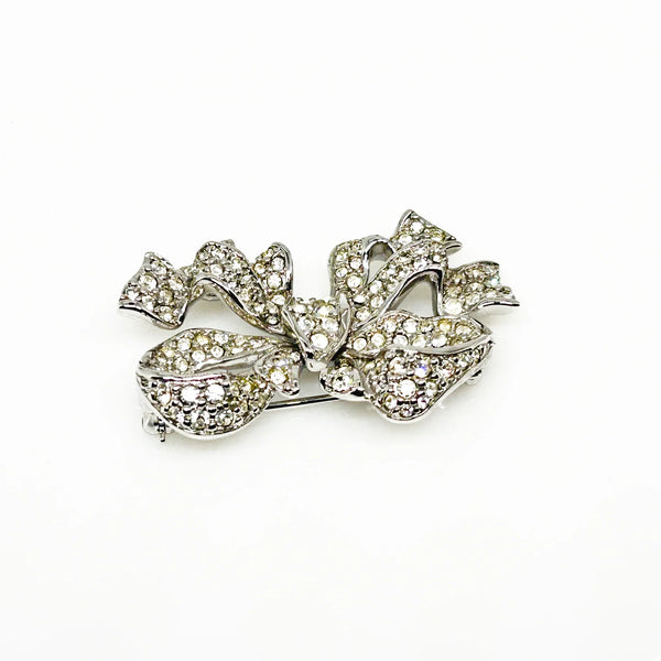 Measuring precisely 1.75 inches, this stunning brooch is meticulously crafted with a rhodium setting and proudly bears the Swarovski signature. Every pave-set stone is present and radiates with captivating brilliance, ensuring this brooch will be a treasured addition to your collection for years to come