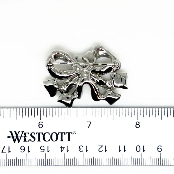 Measuring precisely 1.75 inches, this stunning brooch is meticulously crafted with a rhodium setting and proudly bears the Swarovski signature. Every pave-set stone is present and radiates with captivating brilliance, ensuring this brooch will be a treasured addition to your collection for years to come