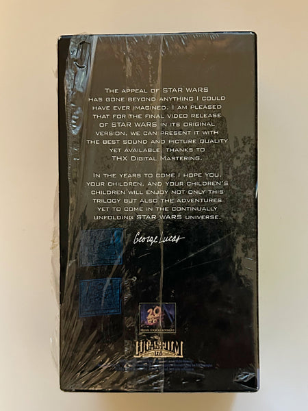 Close-up on the back of a 1995 Star Wars VHS box set showing a printed quote and signature by George Lucas regarding the original theatrical versions and THX Digital Mastering