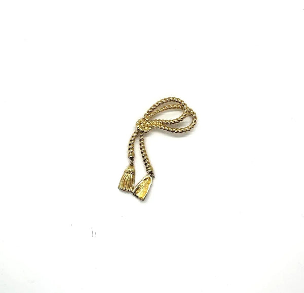 This dramatic Avon gold-tone brooch, a delightful piece from the 1980s, showcases a captivating knotted rope design. The brooch features dangling tassels, adding a touch of vintage charm.