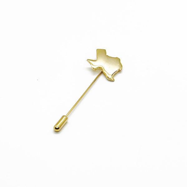Gold-tone Texas state-shaped stickpin from the 1970s, featuring a polished silhouette mounted on a secure needle with protective clutch. Measures 2.5" excluding cap. Vintage lapel pin or tie tack perfect for adding Texas pride to any outfit.